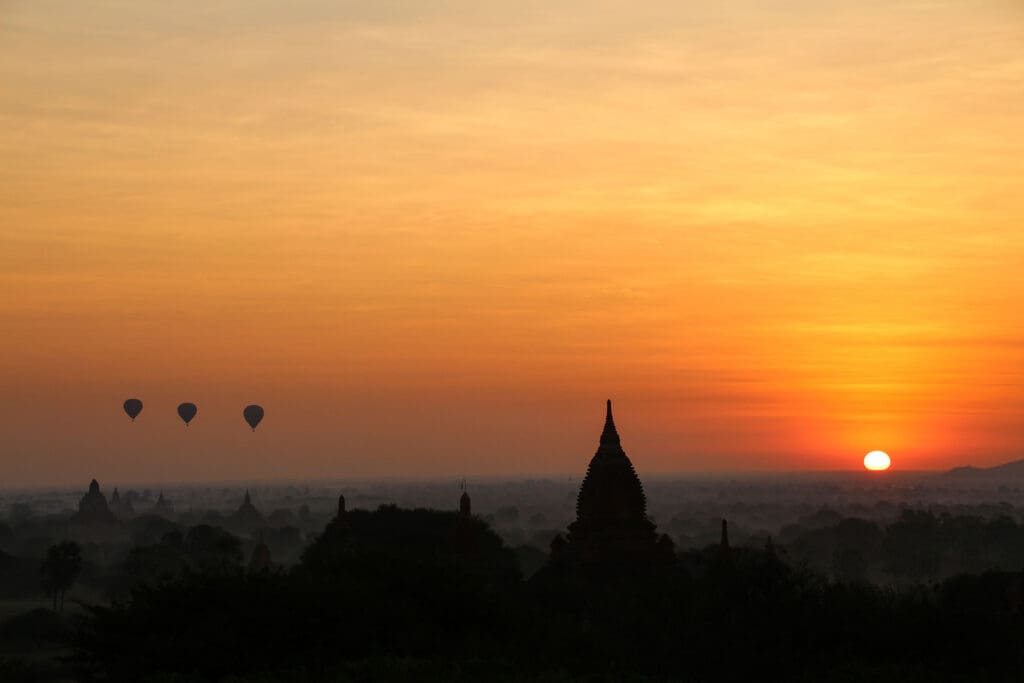 Heißluftballons steigen über Bagan bei Sonnenaufgang