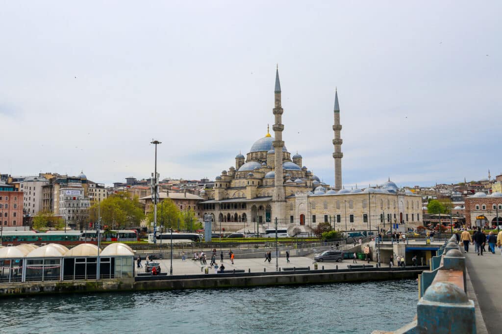View of the New Mosque (Yeni Cami) rising above the Istanbul waterfront as seen from the Golden Horn, Turkey.