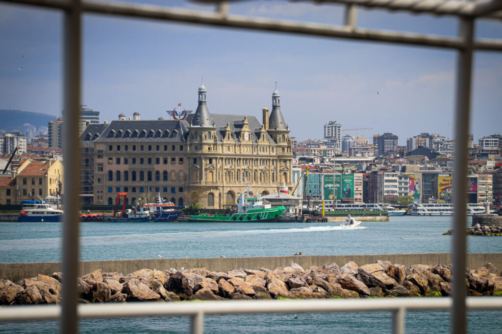 The Istanbul skyline with mosque minarets seen through a framing architectural element, creating a picture-within-a-picture effect, Turkey.