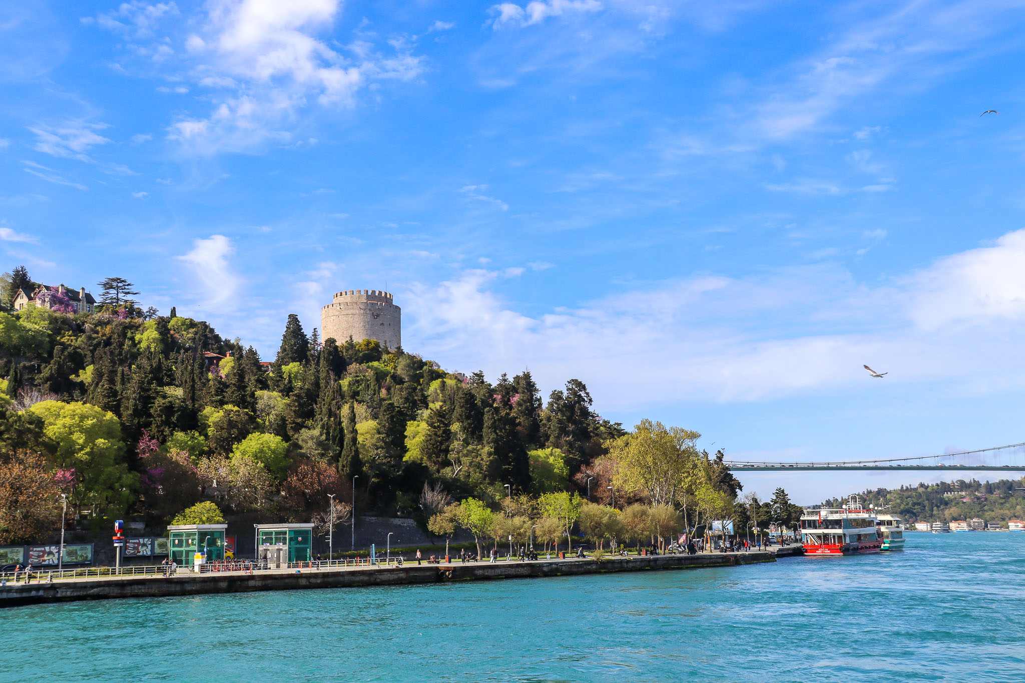 The historic Rumeli Hisarı fortress built in 1452 by Sultan Mehmed II stands on the European shore of the Bosphorus with the suspension bridge visible behind it, Istanbul.