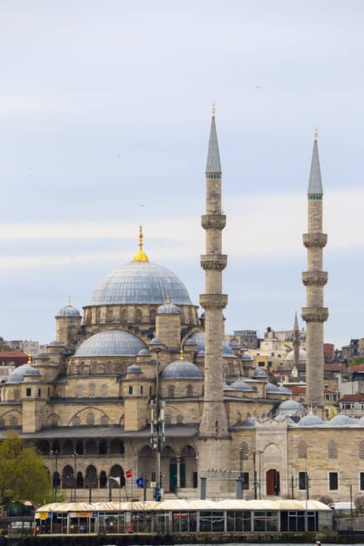 Close-up view of the New Mosque (Yeni Cami) with its tall minarets and large dome in the Eminonu district of Istanbul, Turkey.