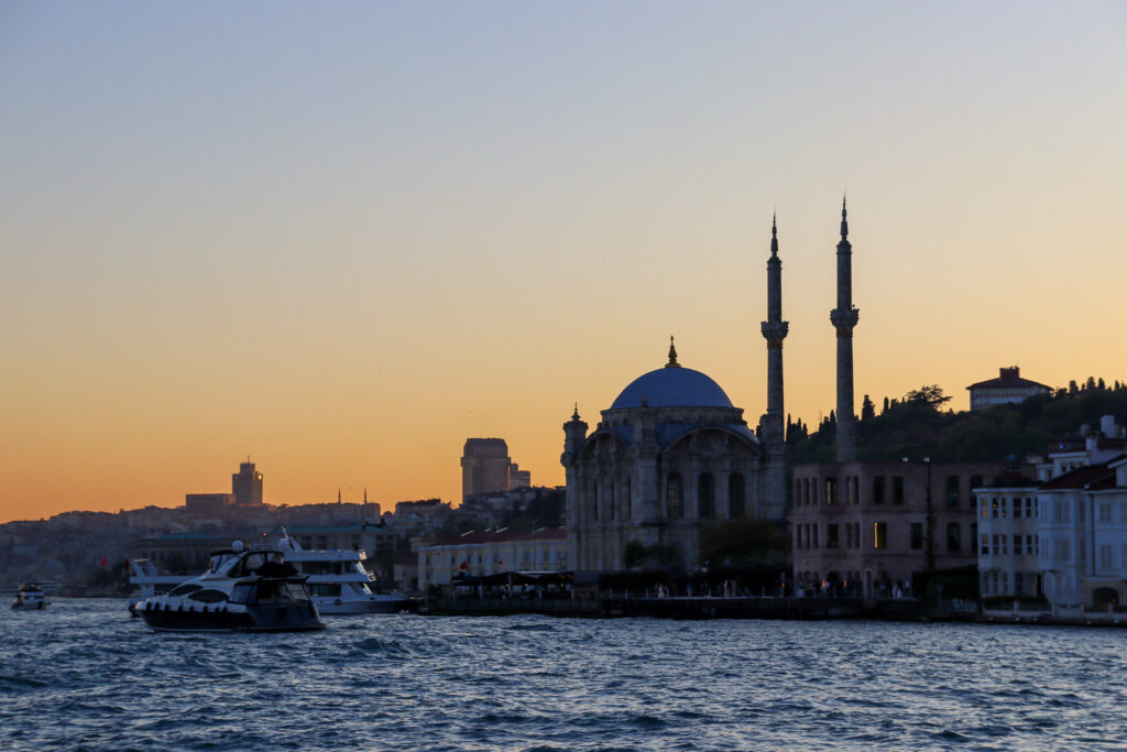 the iconic silhouette of the Süleymaniye Mosque rises above the Istanbul skyline at golden sunset over the Golden Horn, seen from the Bosphorus ferry, Turkey.